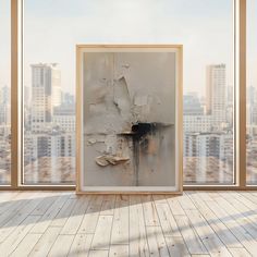 an empty room with a painting on the wall in front of a cityscape