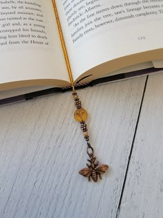 an open book with a necklace on it