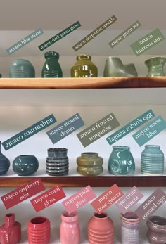 there are many different vases on the shelves in this display case, each with their own name