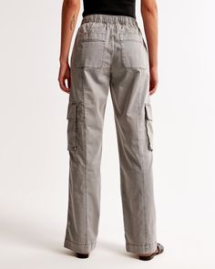 Baggy cargo pants, that are high rise but can be worn at mid or low comfortably, in a drapey twill fabric with an all-over garment dye wash effect and baggy silhouette. Features cargo-inspired details, pockets, zip-hem adjustability and a fully elasticated waistband with functional drawcords. Relaxed Fit Straight Cargo Pants, Relaxed Fit Wide-leg Utility Cargo Pants, Relaxed Fit Cargo Jeans For Spring, Relaxed Fit Cargo Style Straight Leg Bottoms, Mid-rise Cotton Cargo Parachute Pants, Relaxed Fit Cargo Pants With Cargo Pockets For Spring, Utility Cargo Bottoms With Relaxed Fit, Relaxed Fit Utility Cargo Bottoms, Spring Relaxed Fit Cargo Pants With Pockets