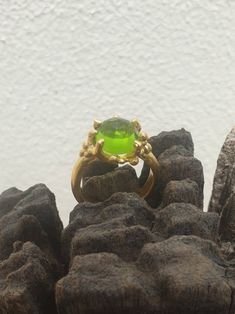 This is gold plated brass peridot ring. A designer handmade ring. It has a design of a coral, holding a green peridot gem. It could be an alternative engagement ring, or a great gift for a loving one. - 14 karat Gold plated brass - Round peridot gem - Free shipping worldwide - Sent in a gift box If you would like to see other rings I have made, please follow this link: https://www.etsy.com/il-en/shop/TamyZurTachshit?ref=seller-platform-mcnav&section_id=17271018 If you would like to go back t Lime Green Gemstone Ring Jewelry, Lime Green Gemstone Ring, Handmade Peridot Wedding Rings, Green Peridot Open Ring Jewelry, Handmade Peridot Ring For May Birthstone, Green Handmade Rings For Formal Occasions, Handmade Green Rings For Formal Occasions, Elegant Green Peridot Crystal Ring, Green Fusion Rings For Formal Occasions