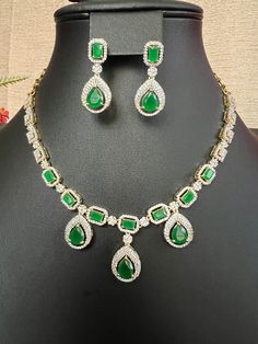 Designer Green Emerald AD Stones  Micro gold Finish  Necklace and Earring Set / Bridal Jewelry / South Indian Jewelry This item is perfect for parties and festivals! DETAILS: Includes one necklace and two earrings. Necklace: 13.5inches. Adjustable length. Chain closure. Weighs 1.45 oz ( 41g).  Earrings: 1.3 inch(es) long. Earring set weighs 0.35 oz (11 g). Earring backs push on/off. Material: Imitation gold Finish Green Emerald  AD Stones Cubic zirconia stones. Finish: Premium Micro gold finish.  NOTE: I try my best to show you photos of my products as they appear in real life, but please note that variations in color occur due to differences in lighting and screen settings.  PRODUCT CARE: - Avoid contact with heat/fire, water, and chemicals such as perfumes or any sprays to prevent produc Gold Plated Jewelry Sets For Party, Gold Jewelry Sets With Matching Earrings For Party, Gold Party Sets For Diwali, Festive Gold Plated Necklaces For Party, Festive Gold Plated Necklace For Party, Festive Gold-plated Necklace For Party, Formal Jewelry Sets With Matching Earrings For Festivals, Formal Jewelry Sets With Matching Earrings, Gold Plated Hand Set Jewelry For Parties