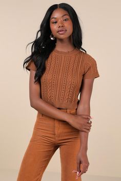 Your autumn style will be truly special a with trendy must-have like the Lulus Modish Ways Rust Brown Cable Knit Short Sleeve Sweater Top! This soft and stretchy sweater boasts a variety of classic designs, including cable, seed, and ribbed knit textures (plus pierced detailing), that makes this piece truly unique. A timeless crew neckline and a fitted, cropped bodice are framed by cute short sleeves, while contrasting ribbed knit trim at the neckline, cuffs, and hem completes the look. Fit: Thi Trendy Brown Knit Top For Layering, Brown Knitted Crew Neck Top, Brown Textured Knit Crew Neck Top, Fall Cropped Cable Knit Sweater With Stretch, Brown Soft Knit Top For Layering, Trendy Pointelle Knit Cropped Sweater For Fall, Trendy Stretch Cropped Sweater In Pointelle Knit, Cropped Pointelle Knit Sweater, Fitted Cable Knit Cropped Sweater For Layering