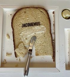 a piece of bread with the word jacquins written on it and a fork