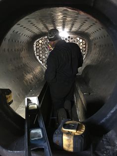 a man is walking down an escalator with luggage on the ground below him