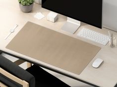 a computer desk with a keyboard, mouse and monitor on it's side table