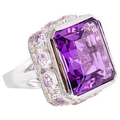 Sunita Nahata presents a stunning and regal 22 carat amethyst cocktail ring. The stunning center stone vibrantly sits on top of a cluster of diamonds and charming crystal quartz. The unique architecture to construct and combine these gemstones makes this ring a true showstopper. Fancy amethyst ring in 18K white gold with diamonds and crystal quartz. Amethyst: 22.22 carat octagon shape. Diamonds: 0.69 carat, G colour, VS clarity. Crystal quartz: 6.64 carat. Gold: 12.3g, 18K white gold. Ring Size: Amethyst Cocktail Ring, Architecture Unique, Bling Ideas, Sapphire Cocktail Ring, Green Sapphire Ring, Diamond Cocktail Ring, Octagon Shape, Gold Cocktail Ring, Gold Cocktail