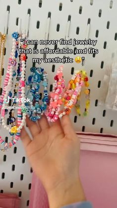 a person holding several bracelets in front of a rack with beads on it and the words, i can never find jewelry that is available and fits my aesthetic