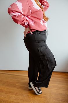 Get ready to flow like never before in our FLOWY WIDE LEG CARGO PANTS. These high-waisted, solid tencel pants feature an elastic waist with adjustable drawstrings for ultimate comfort. With pockets for convenience, these pants are the perfect combination of relaxed and on-trend. Fits true to size. We suggest going with your typical size. Pants have little stretch in the leg and butt. Leah is wearing a size 1x. Want more information about the model? Visit our Lovely Models page. Wash Hand wash co Cargo Style Trousers For Loungewear, Cargo Style Loungewear Trousers, Baggy Utility Bottoms For Loungewear, Utility Style Wide-leg Pants With Elastic Waistband, Utility Wide-leg Pants With Elastic Waistband, Wide Leg Cargo Style Loungewear Pants, Versatile Bottoms With Elastic Waistband, Versatile Bottoms With Elastic Waistband In Rayon, Versatile Rayon Bottoms With Elastic Waistband