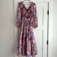 Astr Jannika Wrap Midi Dress. Size Small. Pink And Purple Floral Print. Brand New With Tags! Spring Floral Print Mauve Dress, Mauve Floral Print Dress For Garden Party, Lavender Long Sleeve Dress For Garden Party, Feminine Purple Floral Dress, Mauve Floral Print Midi Dress, Purple Feminine Midi Dress For Garden Party, Feminine Purple Midi Dress For Garden Party, Lavender Maxi Dress For Brunch, Purple V-neck Midi Dress For Garden Party