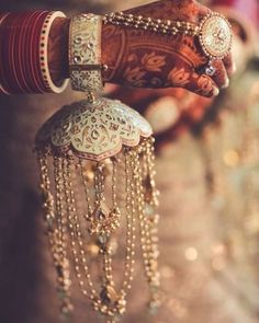 a woman's hands with bracelets and jewelry