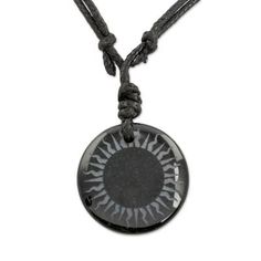 A circular pendant of natural black jade centers a length of adjustable cotton cord. Guatemalan artisan Jorge Lopez crafts this necklace for men and women etching the jade with the image of a sun. Adjustable Black Medallion Necklace, Adjustable Black Medallion Jewelry, Adjustable Black Amulet Necklace, Spiritual Adjustable Sun Design Necklace, Adjustable Spiritual Sun Design Necklace, Adjustable Spiritual Necklace With Sun Design, Black Pendant Jewelry With Waxed Cord, Black Waxed Cord Pendant Jewelry, Adjustable Sun Design Pendant Jewelry