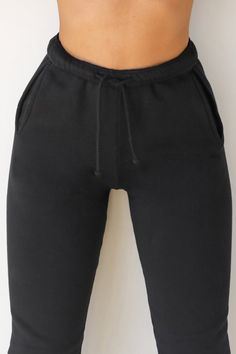 High-waist sweatpants with a relaxed fit and tapered silhouette. These comfy joggers feature side pockets, fitted ankle bands and an elastic waist with adjustable drawstring. Custom knit french terry fabric Brushed mid-weight cotton - ideal for layering Soft, comfortable and made to last Color: Black French Terry Sizing: X/S (0-2), S/M (4-6), M/L (8-10) Model is 5'8" and wearing size X/S Fabric: 100% Cotton Care: Machine Wash Cold With Like Colors.Care: Tumble Dry Low. JOAH BROWN | MADE IN LOS A Sportswear Joggers With Drawstring, Jogging Pants With Drawstring, Athleisure Sweatpants With Drawstring For Workout, Solid Color Sportswear Sweatpants With Drawstring, Athleisure Jogging Pants With Drawstring, Athleisure Drawstring Sweatpants For Workout, Solid Color Sweatpants With Drawstring For Workout, Workout Sweatpants With Drawstring, Relaxed Fit Drawstring Sweatpants For Sportswear