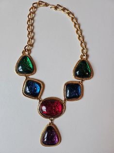 Incredible massive designer multi color large cabachon and gold necklace by KJL for AVON! This amazing 90's collectors necklace is the perfect next addition to your jewelry collection.  This necklace is the prefect statement piece for any outfit, formal or casual.  Dress it up or dress it down with a great T shirt and jeans or a fabulous evening gown. We just LOVE this amazing statement necklace. Get this gorgeous designer vintage necklace for yourself or for someone in your life who loves vintage jewelry! Neck Drop 8 inches Length 11 inches My photos are shots of the original item. Light or dark spots are reflections caused by the lighting. Color deviations can occur depending on the screen being used. Age of items are estimated based on my research and experience. Age differences may occ Navy Blue Purse, 80s Jewelry, Runway Necklace, 90s Jewelry, Jeweled Shoes, Vintage Hair Combs, Designer Necklace, Lighting Color, Blue Purse