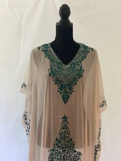 Embroidered Kashmiri Georgette Kaftan - One Size, Long. This Kaftan makes a perfect style statement for summer and your beach vacation. This is a bohemian style maxi dress that can be perfect as a swim coverup or for your beach vacations. Color: White with Green Embroidery Fits small to plus sizes. Measurements with room for comfort: Chest up to: 50 inches Length: 55 inches Care: Hand wash or dry clean only. Embroidered Kaftan For Beach Cover-up, V-neck Embroidered Maxi Dress For Summer, Spring V-neck Kaftan With Chikankari Embroidery, Flowy Beige Kaftan For The Beach, Embroidered V-neck Maxi Dress For Summer, Summer V-neck Embroidered Maxi Dress, Beige Kaftan For Beach Cover-up, Beige Beachwear Kaftan For Vacation, Beach Season Beige Vacation Kaftan