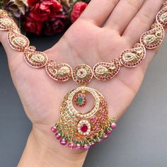 Featuring a paisley design necklace with chandbali earrings in 22ct gold. The set has been embellished with rubies, emeralds and pearls. The necklace weighs 33.8 GMs including 2.77 GMs of hanging beads. The earrings weigh 18.33 GMs including 3.36 GMs in hanging beads. Watch Video Here Gold Plated Meenakari Necklaces, Multicolor Meenakari Gold-plated Necklaces, Gold-plated Meenakari Dangle Jewelry, Ornate Meenakari Yellow Gold Necklace, Gold Meenakari Ornate Jewelry Sets, 22k Gold Jewelry Necklaces, Hanging Beads, 22k Gold Jewelry, Chandbali Earrings