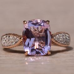 a fancy ring with an amethorate and diamond accents