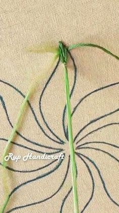 a close up of a piece of cloth with some thread on it and a flower in the middle