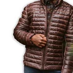 Rugged style meets winter warmth in our Men's Brown Leather Puffer Jacket. Crafted from supple, genuine leather with a rich brown hue, this jacket features quilted puffer insulation for superior heat retention. The classic silhouette is enhanced with a stand-up collar, zippered front, and snug cuffs to keep the cold at bay. Practical side pockets provide storage and hand-warming comfort. Perfect for the fashion-conscious man who doesn't compromise on functionality, this jacket seamlessly transitions from outdoor adventures to city streets. Key features: Premium brown sheepskin leather exterior for durability and style Quilted puffer design for superior insulation Adjustable hem to seal out cold air Multiple pockets for convenient storage Satin lining for a luxurious feel Premium YKK zipper Biker Shirts Women, Spiked Leather Jacket, Mens Leather Blazer, Motorcycle Leather Vest, Racer Jackets, Flannel Vest, Varsity Jacket Women, Leather Puffer Jacket, Cafe Racer Jacket