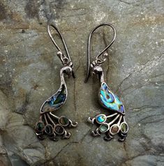 "Sterling Silver and Abalone Peacock Dangle Drop Earrings 1.5\". Marked 925. Condition is good, light tarnish, scuffs and scratches. Thank you for looking! Prices on shop items are fair and reasonable, so all prices are firm.  No reserves, all items sold as-is. Please review photos and description carefully before purchasing.  Please let me know of you have any questions or special shipping requests such as postal insurance.  We are a licensed gold and silver buyer in the state of California; al Silver Earrings With Peacock Design As A Gift, Gift Silver Earrings With Peacock Design, Silver Peacock Design Earrings Gift, Silver Peacock Design Earrings As Gift, Silver Dangle Jewelry With Peacock Design, Gift Peacock Design Dangle Earrings, Peacock Design Dangle Earrings For Gift, Silver Round Earrings With Peacock Design, Chip Beads