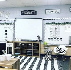 an empty classroom with desks and whiteboards on the wall