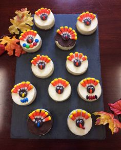 cupcakes decorated like turkeys on a tray