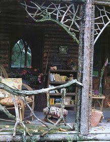 an outdoor area with chairs, bookshelves and trees in the foregrounds