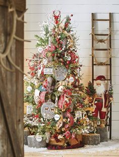 a decorated christmas tree with santa claus and other holiday decorations on it in front of a ladder