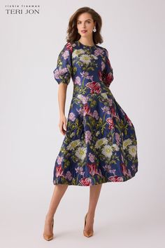 Step into elegance with our exquisite jacquard floral cocktail dress in a captivating blue multi-tone. The luxurious jacquard fabric makes this cocktail dress excellent for your formal events throughout the year. Featuring short puff sleeves, a jewel neck, and flared skirt. The colorful floral pattern also adds a unique touch to the dress. Pair with gold shoes to complete the look. Color: Blue Multi Crew Neckline Puff Sleeves Drop Waistline Flared Pleated Skirt Below The Knee Floral Cocktails, Floral Cocktail Dress, Gold Shoes, Dropwaist Dress, Drop Waist, Jacquard Fabric, Flare Skirt, Dress Details, Formal Event