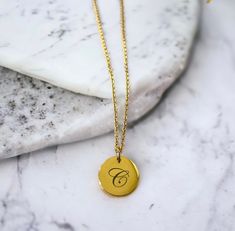 Gold custom laser engraved 16mm round pendant necklace! ✨ See photos for more details and font options! All necklaces are on 16-inch chains, and an extension can be added upon request! Up to 10 letters can be added to each side of the pendant - Please keep in mind that the more you add to one pendant the smaller your font will be and this could affect the visibility of your engraving.  You can choose to add your initial(s), Full name, a loved one's name and birth date, etc.  Your options are endless! If you would like an engraving that contains more than 10 letters, please leave that note in the personalization box and message me with your engravings!  Handmade freshwater pearl charms can be added, please choose that option in the box below if you would like to add a charm. Handmade locall Gold Round Laser Engraved Charm Necklaces, Minimalist Laser Engraved Round Pendant Necklace, Gold Charm Necklace With Laser Engraved Round Pendant, Personalized Round Pendant Medallion Necklace For Gifts, Personalized Round Medallion Necklace As Gift, Personalized Round Medallion Necklace Gift, Personalized Round Medallion Necklace For Gift, Round Stainless Steel Laser Engraved Necklace, Round Laser Engraved Necklaces For Personalized Gift