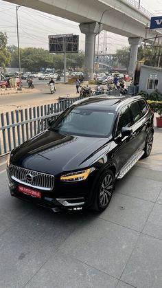 a black car parked in front of a building