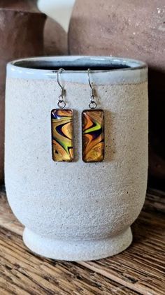 I love the vibrant color combo of these earrings. Made using acrylic paint pouring technique, each piece is truly  one- of-a-kind and lots of fun to create! Light weight and comfortable to wear. Setting and ear wires are hypoallergenic stainless steel. Dimensions:   Rectangle -  25x10mm                           Round - 12 mm Items are photographed up close so that you can see their beautiful details. I do my best to ensure that the photos are as true to color as possible. Please keep in mind that color can vary from monitor to monitor and that we all see colors differently. Vibrant Colorful Earrings For Gifts, Artistic Yellow Jewelry With Matching Earrings, Nickel-free Multicolor Artsy Earrings, Artsy Multicolor Nickel-free Earrings, Artsy Multicolor Nickel Free Earrings, Artistic Adjustable Yellow Earrings, Artsy Yellow Jewelry With Ear Wire, Vibrant Drop Earrings Jewelry Gift, Vibrant Drop Earrings For Gifts