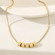 Durable and stylish, our waterproof necklace is crafted for both functionality and fashion. Perfect for any occasion, it's the ideal accessory for those who appreciate durability and timeless elegance. Perfect for the minimalist and a beautiful piece to layer with. A true versatile statement piece that you can wear straight from the pool to dinner! - 18K gold plated / stainless steel - Waterproof technology - 18" in length - Necklace + 1 cube (initial or sign) = $45 - Additional cubes with lette Everyday Adjustable Gold Name Necklace, Adjustable Name Necklace Gift, Minimalist Box Chain Jewelry As Gift, Classic Necklace With Adjustable Chain As Gift For Her, Minimalist Adjustable Choker Necklace, Trendy Hypoallergenic Necklace As A Gift, Trendy Hypoallergenic Necklace Gift, Trendy Hypoallergenic Necklaces As Gifts, Elegant Adjustable Name Necklace With Delicate Chain