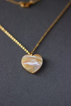 This delicate unique necklace was made of natural mother of pearl beige heart pendnat and high quality gold tone stainless steel chain with gold tone lobster claw. The chain is from lead & nickel free metal. Perfect jewelry for everyday wear and a great gift for someone special! The length of necklace is 45 cm or 17.7 inches. Other necklaces of my shop you can see here: https://www.etsy.com/shop/NaTavelli?section_id=14843046&ref=shopsection_leftnav_5 Thanks for a visit. Natural Stones Round Necklace For Her, Natural Stone Necklaces As Gift For Her, Natural Stones Necklace Gift For Her, Natural Stones Necklace For Her, White Spiritual Shell Necklace As A Gift, Spiritual White Shell Necklace Gift, White Spiritual Shell Necklace, White Heart Pendant Clavicle Chain Jewelry, White Heart Pendant Clavicle Chain