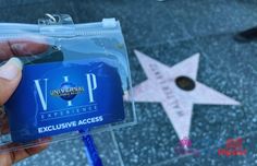 a person holding up a plastic business card in front of a star