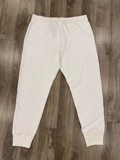 Description: Polo Ralph Lauren cuffed sweatpants with pockets and drawstrings Flaws: Small stain on left thigh, please see pictures. Size: Large Waist: 34-36" Inseam: 29.5" Length: 39" Thigh: 26" Leg Opening: 11" Brand: Polo Ralph Lauren Era: 2010s Color: White Store Item #IN994 White Joggers With Ribbed Cuffs, White Casual Joggers With Side Pockets, White Athleisure Joggers With Drawstring, Sporty Plain Sweatpants For Loungewear, Casual White Joggers For Leisure, White Sportswear Joggers With Side Pockets, White Joggers With Side Pockets, White Drawstring Joggers For Jogging, Plain Sweatpants For Loungewear