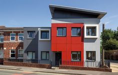 a red and grey building with two stories