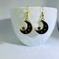 "Gold Plated Enameled Moon & Star Charm Earrings Material: Zinc Based Alloy (Lead and Nickel Safe) Size: 24mm x17mm (1\" x 5/8\") Color: Gold Plated/Black Nickel free ear-wire  Join my facebook group to see when new items are available- https://www.facebook.com/radcrafty Instagram- https://www.instagram.com/radberry1/" Star Earrings Dangle, Moon Gold, Kawaii Earrings, Earrings Star, Moon And Star Earrings, Crescent Moon Earrings, Black Moon, Gold Moon, Celestial Jewelry