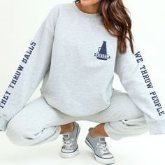 "These cute & funny custom cheer sweatshirts are personalized with each cheerleader's name on the front, and the sleeves are printed with \"They Throw Balls / We Throw People.\"  It's printed just for you on the beloved, buttery soft Gildan 18000 sweatshirt.  These are a relaxed, flattering unisex fit- if you're a looking for a fitted style you may want to size down, for a more relaxed fit go with your usual size, and for an oversized look size up several sizes. Models depicted are approx 5' 8\" Cheerleading Letter Print Crew Neck Sweatshirt, Cheer Sweatshirts, Cheerleading Team, Cheerleading Gifts, Cheer Shirts, Fitted Style, Print Sweatshirt, Oversized Look, Printed Sweatshirts