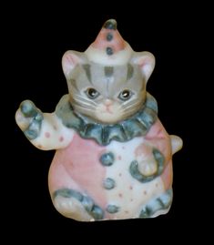 a ceramic figurine of a cat wearing a hat