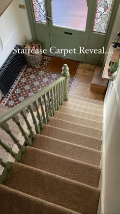 stairs lead up to the second floor with stained glass windows