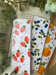 three bookmarks with fruit designs on them