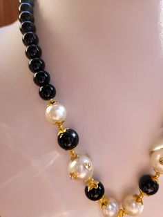 Black onyx and freshwater pearl necklace.  Chain is 8mm to 10mm onyx and pearl.  Pendant is large 3.75 inch pear shape with 2mm round clear and black Austrian crystal.  Center of pendant has a one inch hand painted portrait of a couple.  Back of pendant has a floral engraving.  14K solid gold electroplated. Classic Black Necklace With Pearl Pendant, Elegant Black Pearl Drop Necklace, Classic Black Pearl Drop Necklace, Classic Black Pearl Chain Necklace, Formal Black Jewelry With Pearl Chain, Black Pearl Chain Jewelry For Formal Occasions, Elegant Black Beaded Pearl Necklace, Elegant Black Pearl Necklace For Evening, Formal Black Pearl Chain Jewelry