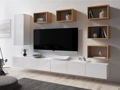 a modern living room with white furniture and wooden shelving units on the wall, including a large flat screen tv