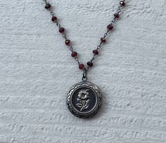 This necklace is handmade with a 3mm genuine garnet rosary chain and a flower locket pendant. The locket opens up so you can place a photo inside.  This necklace is hypoallergenic. (Cadium free, lead free, and nickel safe) Garnet is an energizing stone that promotes passion and love.  The necklace comes in a ribbon-wrapped box, ready to be gifted. If you would like to leave a note, you can do so during checkout. Necklaces Ideas, Handmade Pendant Necklace, Mazzy Star, Crystal Necklaces, Dope Jewelry, Rosary Chain, Funky Jewelry, Jewelry Lookbook, Jewelry Inspo