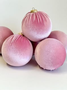 five pink ornaments sitting on top of each other