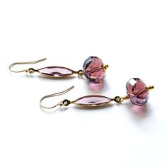 "Simply elegant earrings in dark plum crystals with gold combine vintage open back bezel set navettes above faceted onion shape rondelles. A Mas Collected exclusive, perfect for the season! Era: Mid Century. Measurements: Overall length, 2.75\", dangles 1.75\". Width is .5\" Markings: 1/20 14/K Materials: Salvaged machine cut crystals in dark plum, new gold filled findings. Precious metal: new 14K G. F. ear wires, dangle wires. Condition: Vintage: Very good. New: Excellent. Ships fast. Arrives g Elegant Faceted Round Bead Crystal Earrings, Elegant Faceted Glass Jewelry, Elegant Wire Wrapped Crystal Earrings With Round Beads, Elegant Wire Wrapped Round Crystal Earrings, Elegant Purple Wire Wrapped Crystal Earrings, Elegant Glass Jewelry With Wire Wrapping, Elegant Purple Earrings With Faceted Beads, Elegant Purple Round Bead Crystal Earrings, Elegant Purple Crystal Bead Earrings