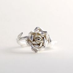 Sterling Silver Rose Ring, Handmade Silver Ring, Women Flower Ring This beautiful, delicate open rose ring would make a stunning statement piece. The band resembles the delicate stem of the rose and every ring is individually handmade so that no two pieces are exactly the same! This makes a truly special gift for yourself or a loved one. * Ring band Material: Sterling Silver * Size of Rose: Approx 1.5 cm (0.59in) diameter 0.6 cm (0.23 in) height * Ready to Ship in 2-4 business day * Made in the Silver Flower Ring With Roses For Wedding, Silver Wedding Ring With Roses, Elegant Rose Sterling Silver Flower Ring, Elegant Rose Flower Ring In Sterling Silver, Rose Gold Sterling Silver Flower Rings, Elegant Sterling Silver Rose Design Flower Ring, Elegant Floral Rings With Rose Details, Elegant Sterling Silver Rings With Roses, Dainty Rose Design Flower Ring For Gift