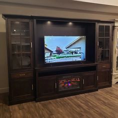 a large entertainment center with a flat screen tv mounted on it's side wall