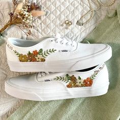 Fresh all white Vans Authentic trainers embroidered with an abundance of tiny flowers in your colour scheme and finished with a name, date, initials or words of your choice. Each pair is hand made to order and stitched with high quality embroidery thread which is washable and fade resistant.  If you're looking for something a little more bespoke, I offer a limited number of fully custom hand embroidered trainers tailored to your wishes. Consider your wedding theme, your favourite flowers, your bouquet and more all tailored to your budget. We can work together to create something perfect for you. Check out my Etsy store for the 'custom order' listing, please read item description before purchase. I'm on Instagram! Follow me @OliveString for extra design inspiration and sneak peeks of work i Spring Sneakers With Floral Embroidery, White Embroidered Sneakers For Summer, White Embroidered Sneakers For Spring, Casual White Embroidered Sneakers, White Casual Sneakers For Wedding, White Casual Wedding Sneakers, Spring Embroidered Sneakers With Logo, White Casual Sneakers With Floral Embroidery, White Cotton Sneakers With Floral Embroidery